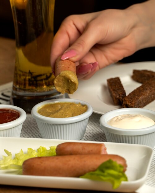 Sausage with mustard and a glass of beer