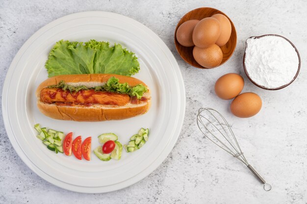 パンとレタスにソースをかけたソーセージ。