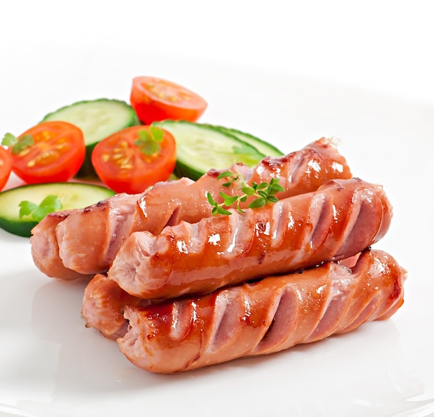 sausages on the grill and salad