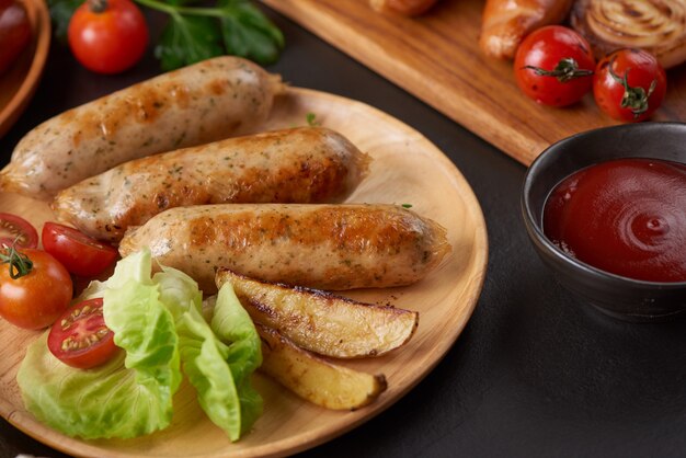 sausages and ingredients for cooking. Grilled sausage with the addition of herbs and and spices