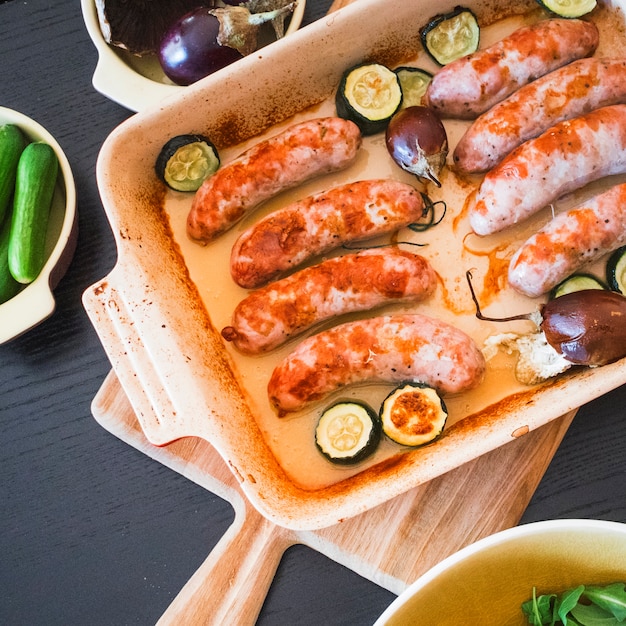 Sausages roasted in baking pan with vegetables