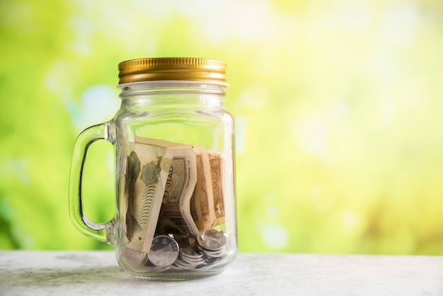 Savings jar on blurred background