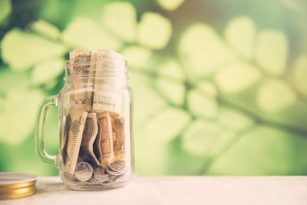 Savings jar on blurred background