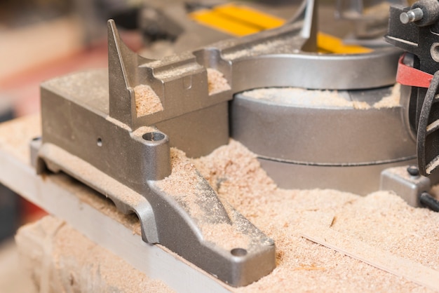 Saw dust near the power tool on workbench