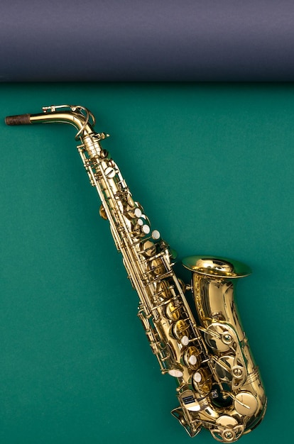 Saxophone on a green background top view