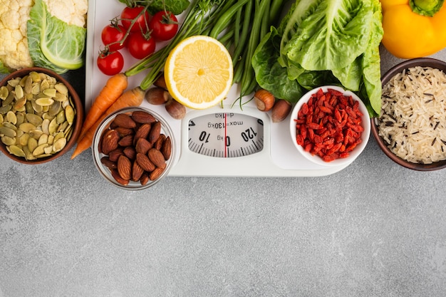 Scale with groceries on gray background