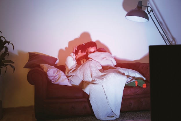 Free photo scared couple watching a movie