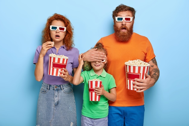 Famiglia di zenzero spaventata in posa con popcorn