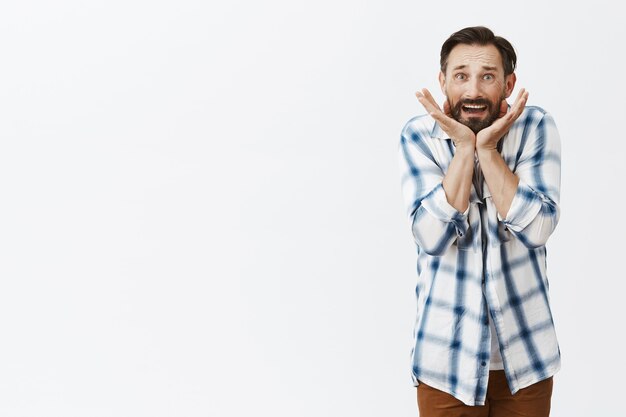 Scared and insecure bearded mature man posing