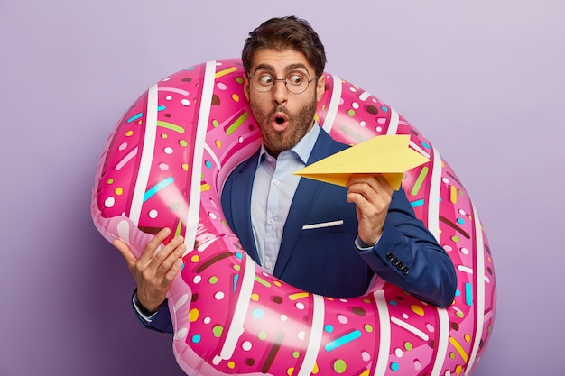 Scared shocked male lawyer throws hand made paper plane