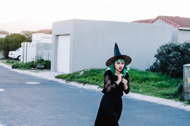 Free photo scared witch on suburban street