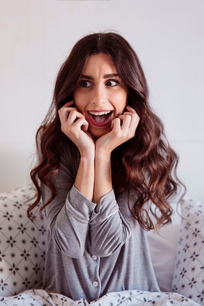 Free photo scared woman in bed