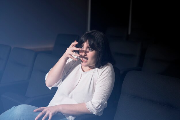 Scared woman in cinema