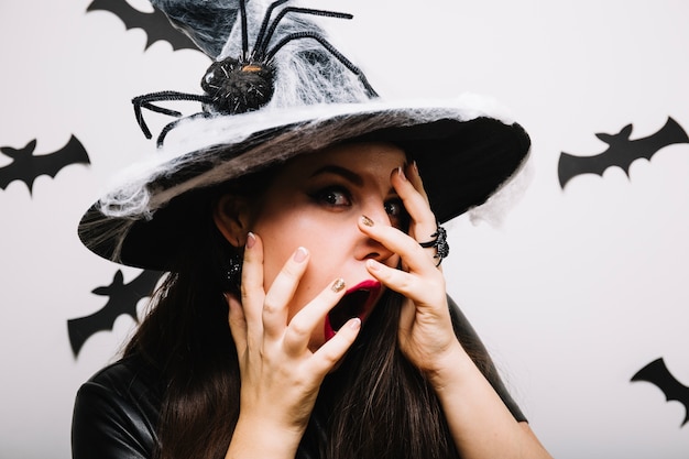 Free photo scared woman in halloween hat