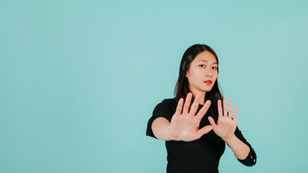 Scared woman making defensive gesture