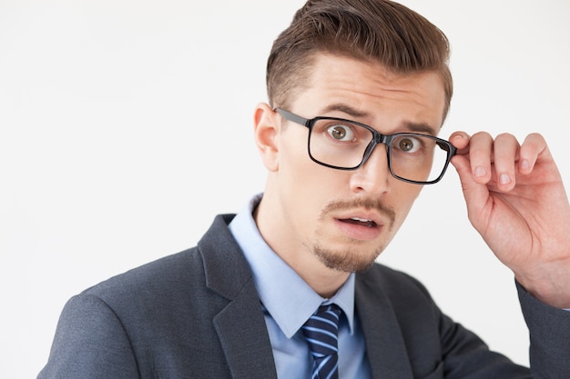 Scared Young Business Man Adjusting Glasses