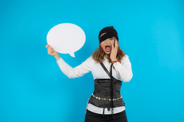 Scared young pirate girl holding idea board. and screaming. High quality photo