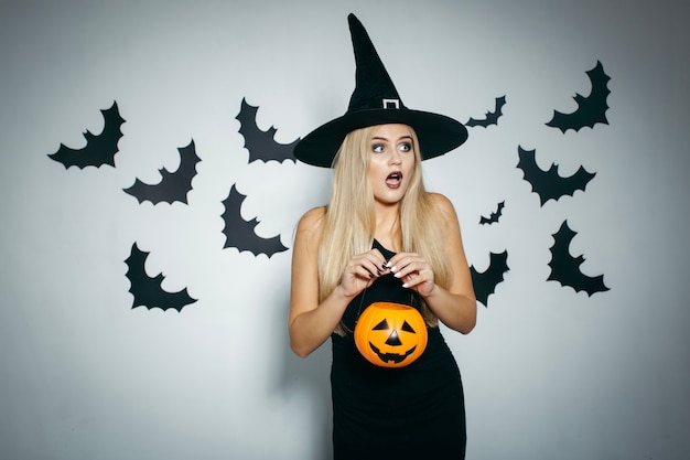 Scared young woman with pumpkin