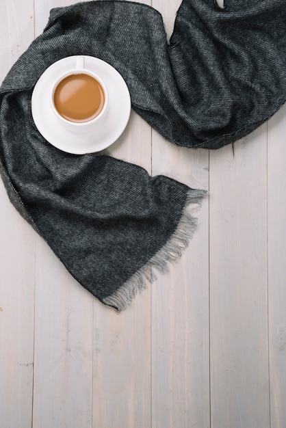 Scarf near cup of drink