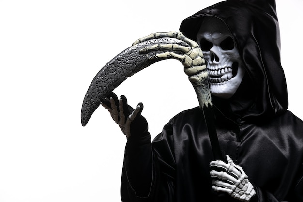 Scary grim reaper in black clothes with scythe on white