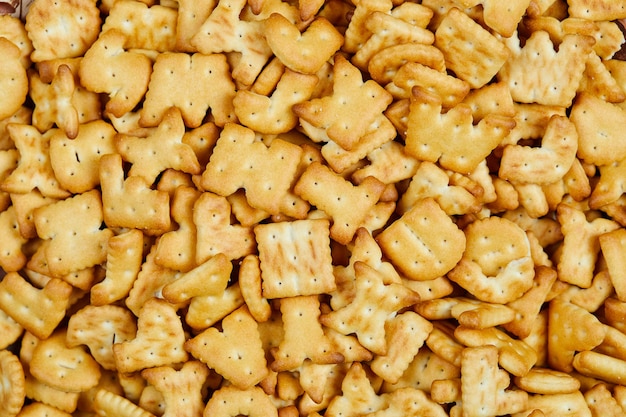 Scattered alphabet crackers on the table. Close up.