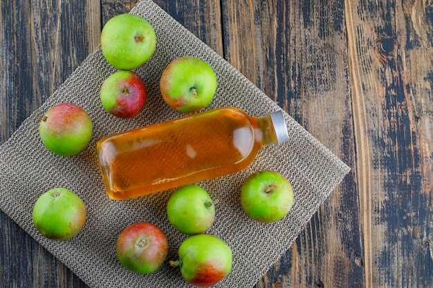 Scattered apples with drink flat lay on wooden and placemat background