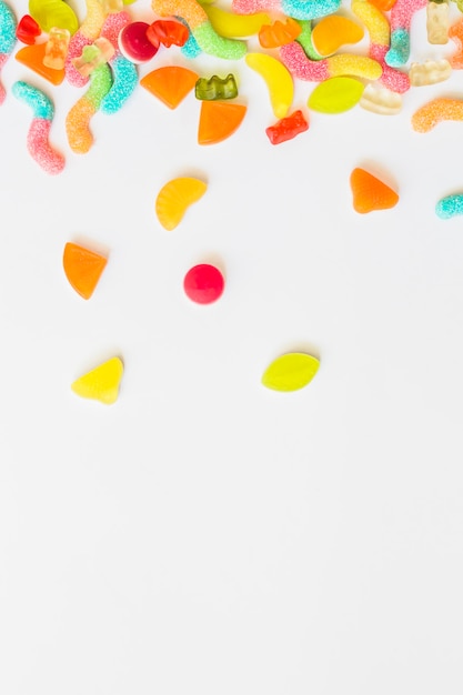 Scattered candies on white table