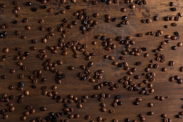 Scattered coffee beans on table