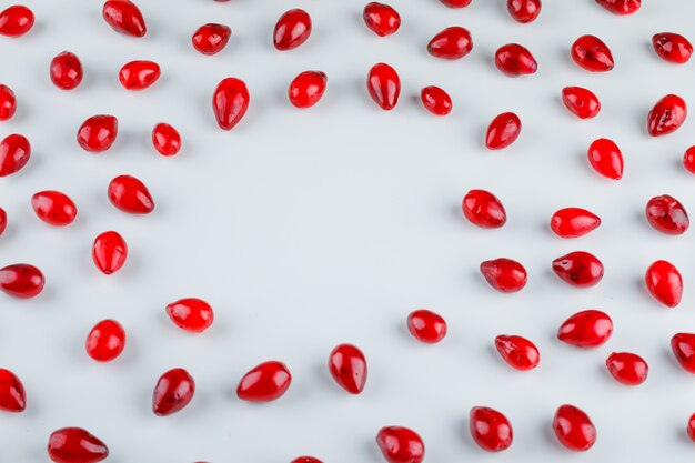 Scattered dogwood berries on white. high angle view.