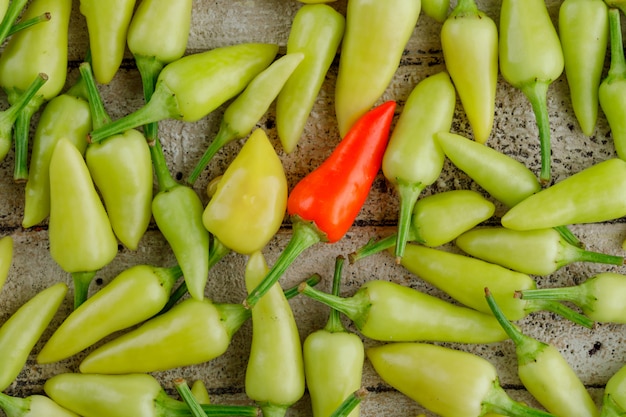 Scattered peppers on wooden,