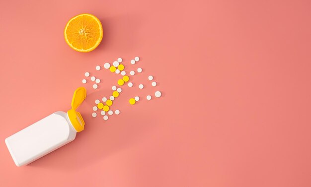 Scattered pills on a pink background flat lay