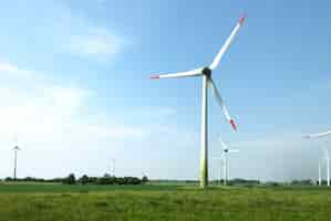 Free photo scenery of wind turbines in the middle of a field under the clear sky