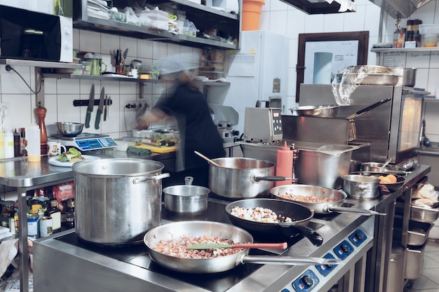 Free photo behind the scenes of brands. the chef cooking in a professional kitchen of a restaurant meal for client or delivery.