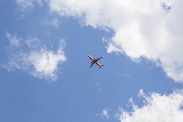 Scenic shot of an airplane flying under a beautiful cloudscape