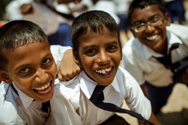 School children dressed in uniform have fun and play in the schoolyard. 