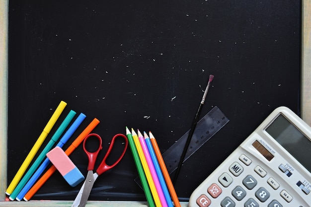 School equipment with chalkboard background