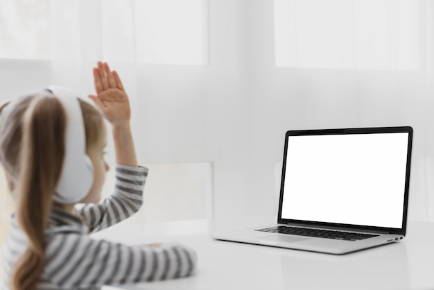 Free photo school girl attending online classes