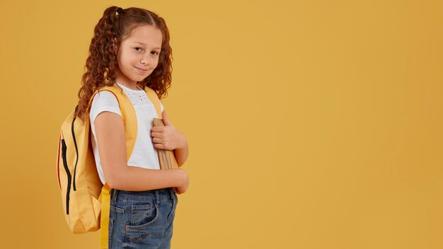 School girl standing side view copy space