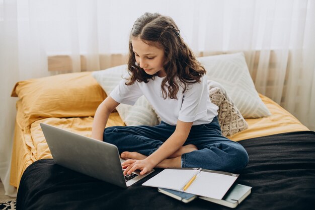 School girl studying at home, distant learning