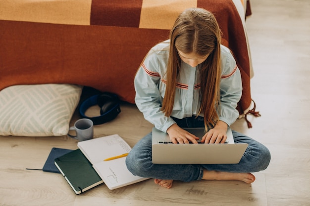 School girl studying at home, distant learning