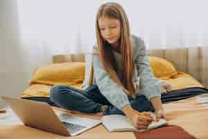 Free photo school girl studying at home, distant learning