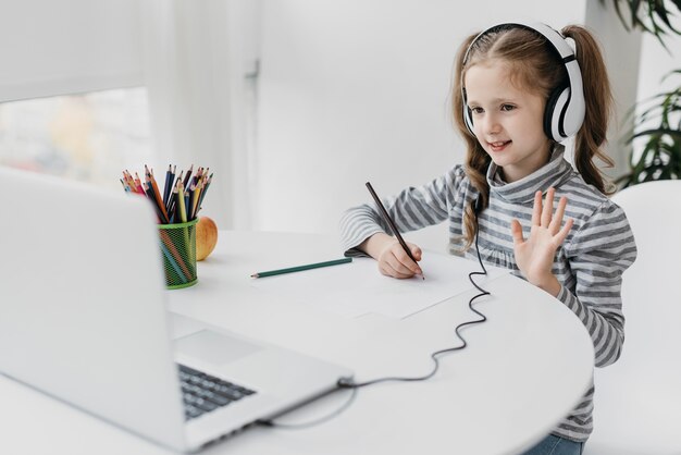 School girl wearing headphones virtual school