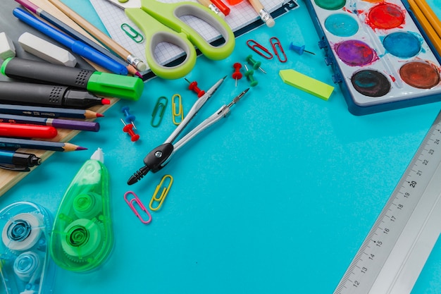 School kit in mess on blue background