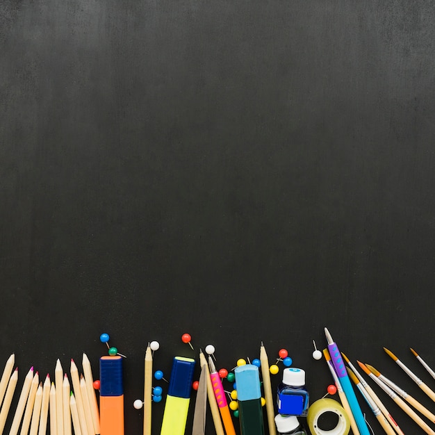 School materials on black desk