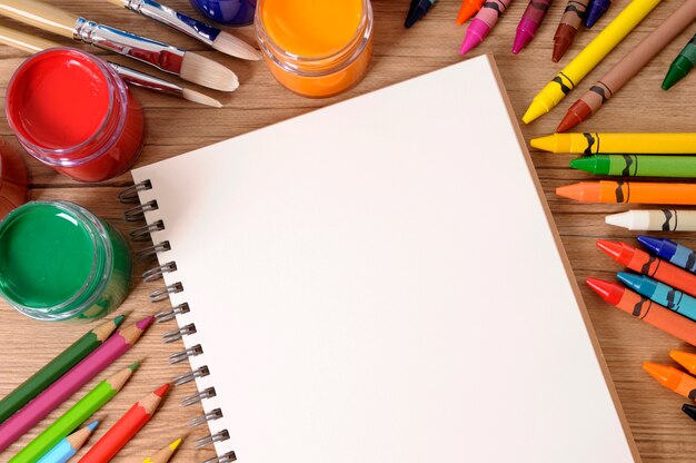 School notebook with art equipment