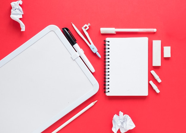 Free photo school and office supplies on red background