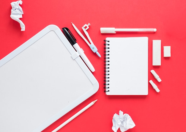 School and office supplies on red background
