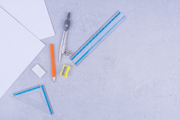 School or office tools with sticky notes on grey.