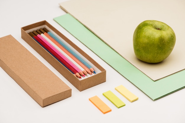 Free photo school supplies and apple on white table