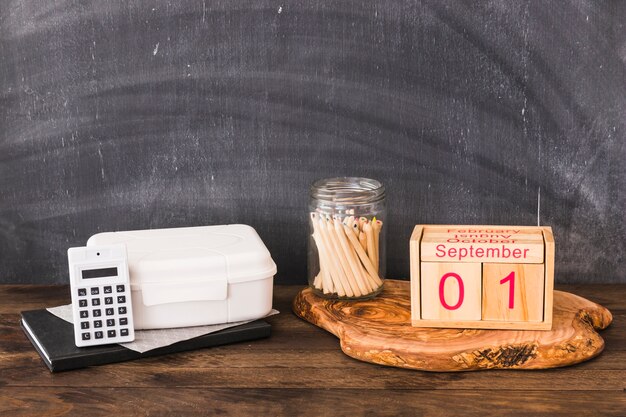 School supplies and food near chalkboard